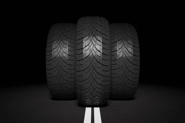 Three tires on black background