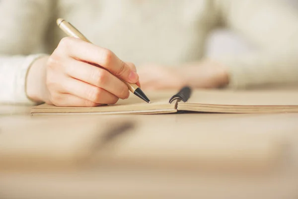 Female writing in notepad — Stock Photo, Image