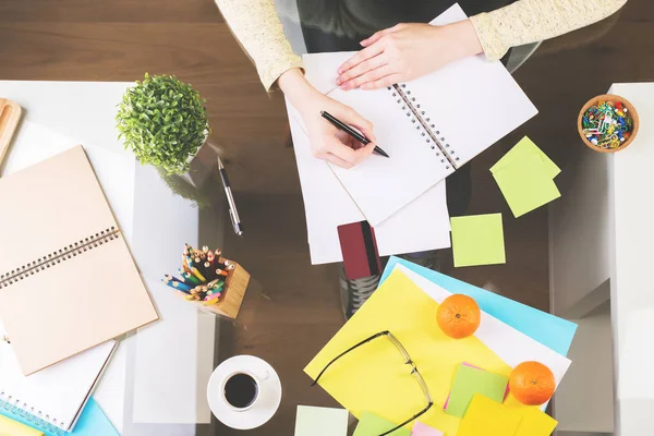 Woman writing in spiral notepad top — Stock Photo, Image