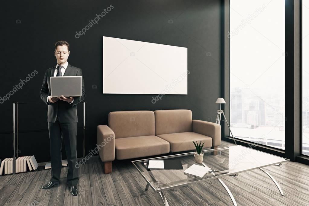 Thoughtful businessman with laptop