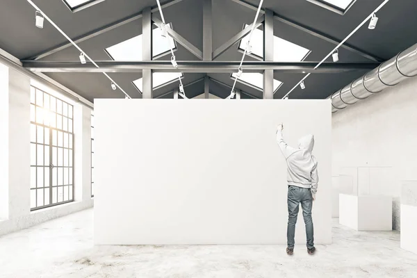 Guy drawing in warehouse interior — Stock Photo, Image