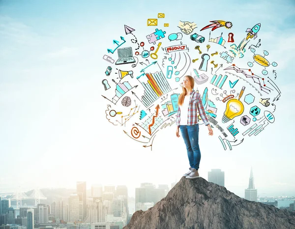 Happy young european girl standing on mountain top with creative business sketch. New York city background. Leadership concept — Stock Photo, Image
