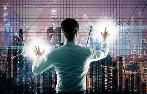 Back view of young businessman managing business charts on city background. Trade concept — Stock Photo, Image