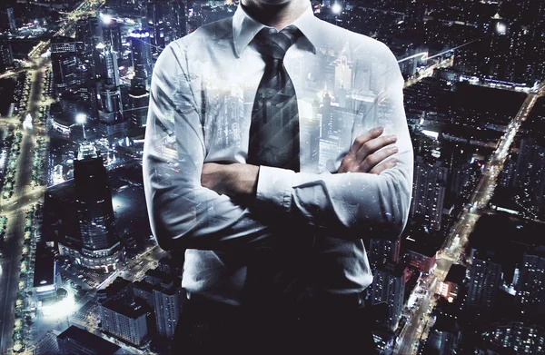 Businessman with folded arms on night city background. Employment concept. Double exposure — Stock Photo, Image