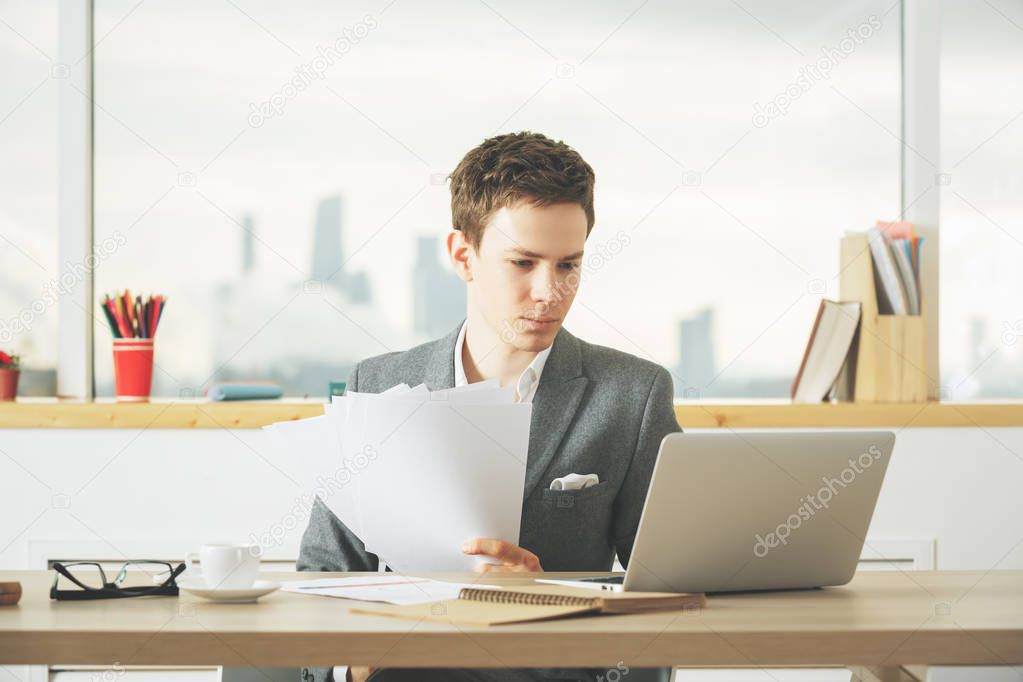 Handsome businessman working on project