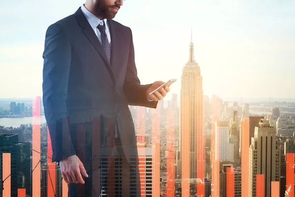 Businessman using smartphone on bright New York city background with abstract projected business chart bars. Trading concept. Double exposure — Stock Photo, Image