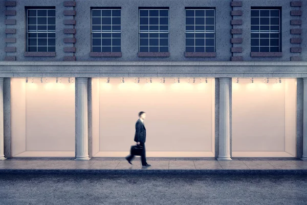 Man passing storefront at night — Stock Photo, Image