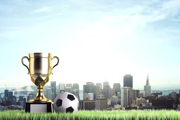 Золотой кубок победителя с футболом помещен на траву. Городской фон с копировальным местом. Понятие чести. 3D рендеринг — стоковое фото