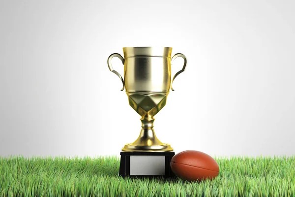 Taça do vencedor de ouro com bola de rugby colocada na grama. Fundo cinza com espaço de cópia. Conceito do campeonato. Renderização 3D — Fotografia de Stock