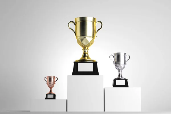Copas de oro, plata y bronce colocadas sobre pedestales blancos. Fondo claro. Concepto de premio. Maquillaje, renderizado 3D —  Fotos de Stock