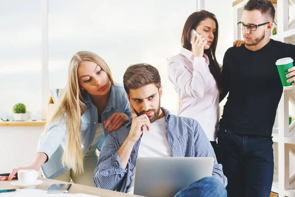 Attraktive junge europäische Gruppe, Geschäftsleute und -frauen, die an Projekten im modernen Büro mit Laptop, Smartphone, Papierkram und anderen Dingen auf dem Schreibtisch arbeiten. Teamkonzept — Stockfoto