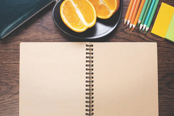 Boş not defteri ve meyve üstünde okul sırası 