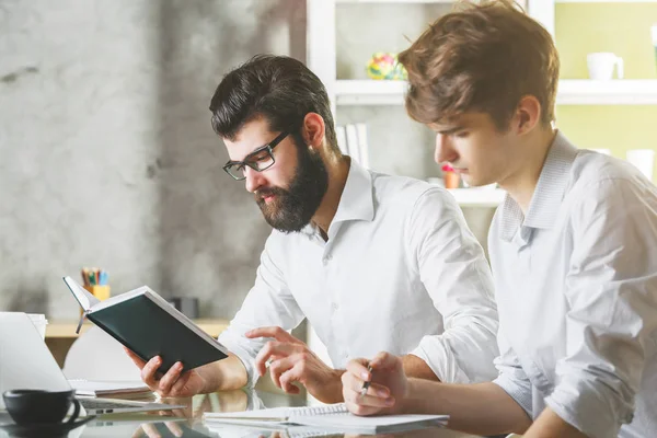 Zwei kaukasische Geschäftsleute arbeiten gemeinsam an einem Projekt — Stockfoto