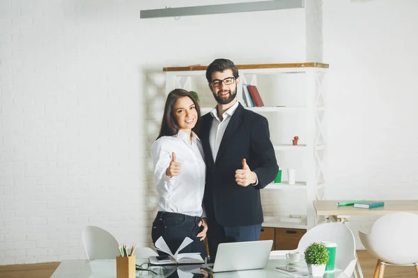 Attractive man and woman showing thumbs up — Stock Photo, Image