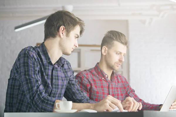 Porträt zweier attraktiver kaukasischer Jungs, die an einem Projekt am Arbeitsplatz arbeiten. Teamwork-Konzept — Stockfoto