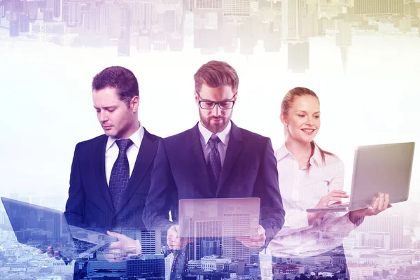 İşadamları ve soyut şehir arka plan üzerinde dizüstü bilgisayarlar kullanan kadın. Ekip çalışması kavramı. Çift pozlama 