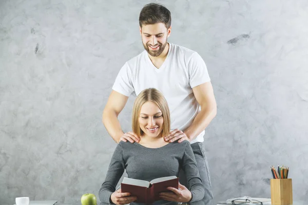 Business partners giving massages at workplace. Break concept