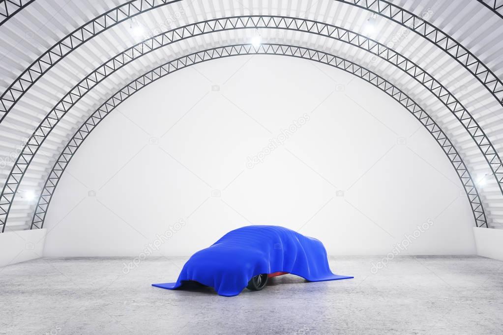 Abstract warehouse interior with car under blue cloth. Design concept. 3D Rendering 