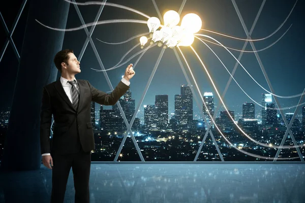 Businessman holding light bulb balloons on in empty concrete interior with panoramic night city view. Idea concept. 3D Rendering — Stock Photo, Image