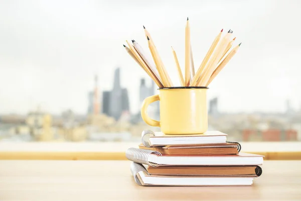 Iron mug with pencils and diary — Stock Photo, Image