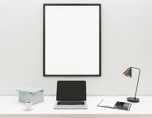 Lugar de trabajo con ordenador portátil y marco en blanco —  Fotos de Stock