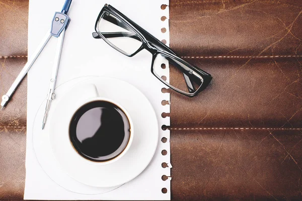 Desk top with coffee, glasses and supplies — Stock Photo, Image
