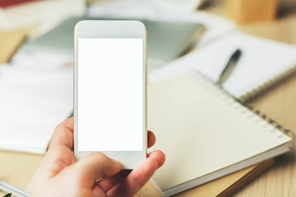 Hand holding white smartphone — Stock Photo, Image