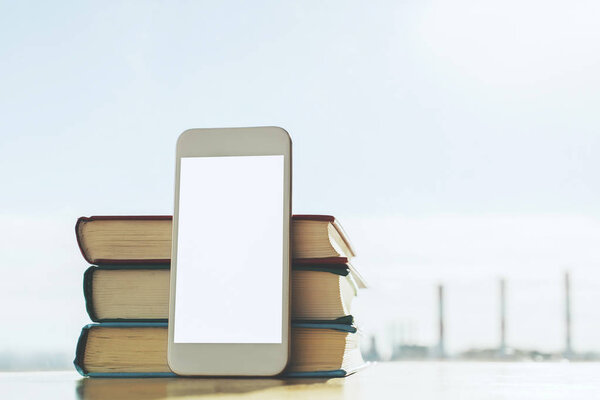 White smartphone and books