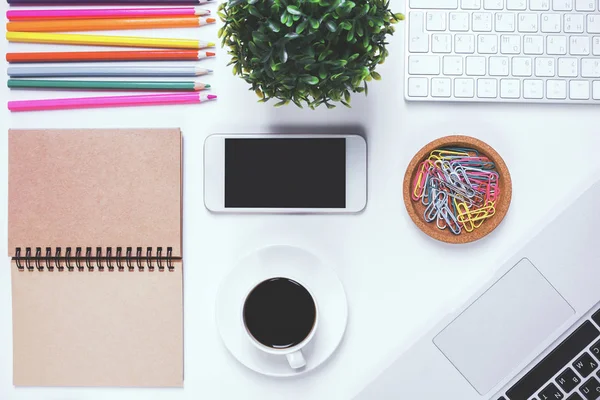 Modern workspace with blank keyboard and smartphone