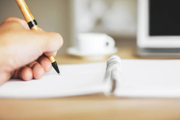 Hand writing in blurry notepad — Stock Photo, Image