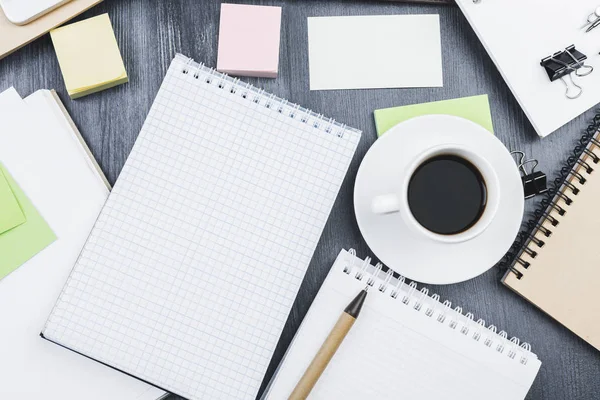 Contemporary table with notepad and coffee — Stock Photo, Image