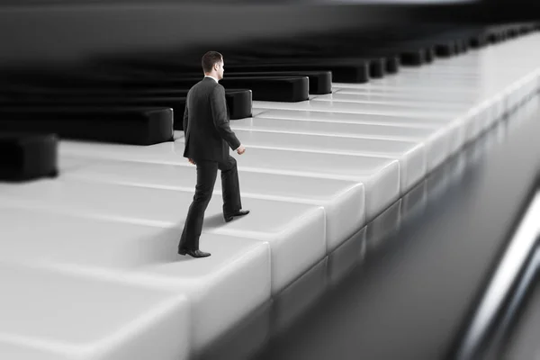 Businessman walking on piano keys — Stock Photo, Image