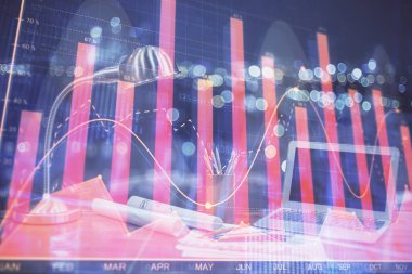 Masası ve kişisel bilgisayarı olan borsa grafiği. Çifte maruziyet. Mali analiz kavramı.