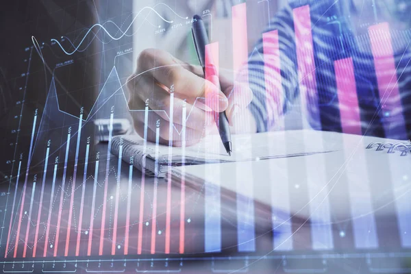 Financial forex graph drawn over hands taking notes background. Concept of research. Double exposure — Stock Photo, Image