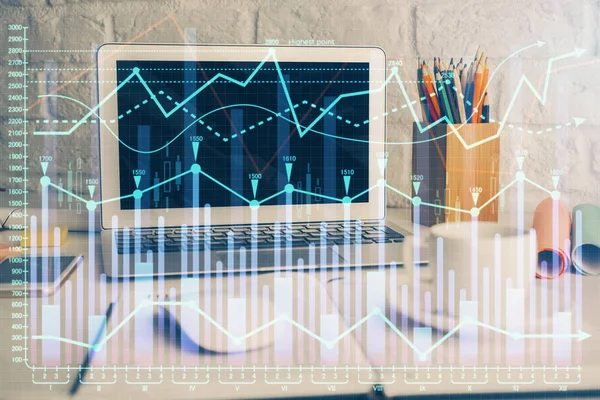 Financial graph colorful drawing and table with computer on background. Double exposure. Concept of international markets.