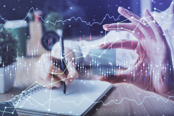 Forex chart displayed on woman's hand taking notes background. Concept of research. Multi exposure