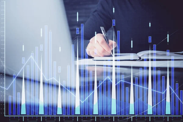 Double exposure of businessman with laptop and stock market forex chart.