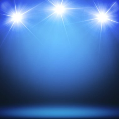 Üç spot lambalı konser sahnesi.