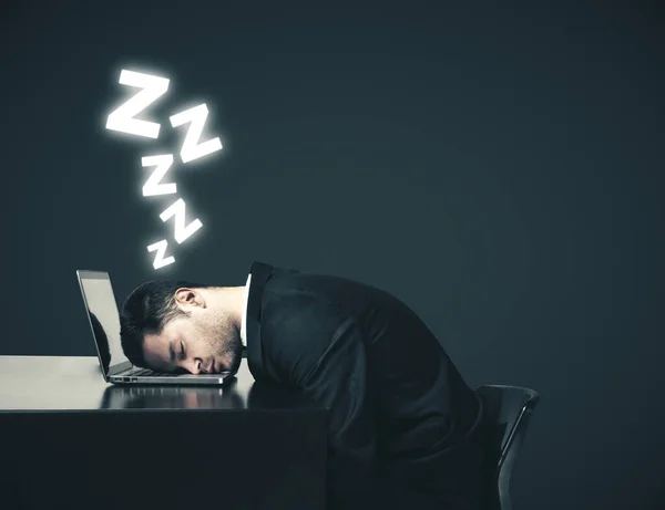 Businessman sleeping on laptop in office. — Stock Photo, Image