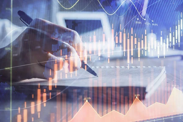 Financial charts displayed on womans hand taking notes background. Concept of research. Double exposure — Stock Photo, Image