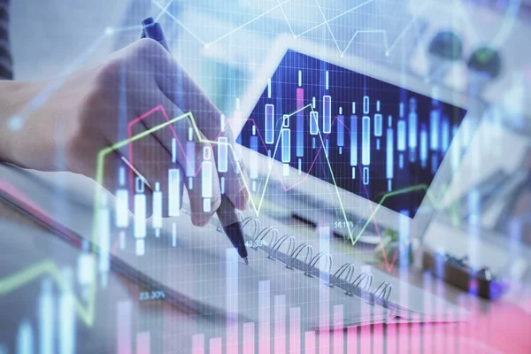 Financial forex graph drawn over hands taking notes background. Concept of research. Multi exposure