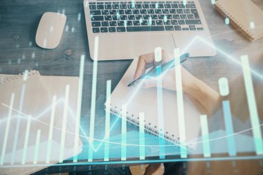 Finansal grafik WOMANS el notları arka plan alarak görüntülenir. Araştırma kavramı. Çoklu pozlama