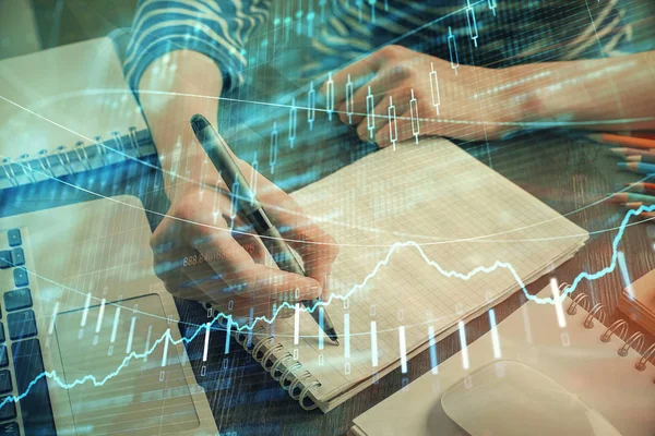 Financial chart drawn over hands taking notes background. Concept of research. Double exposure — Stock Photo, Image