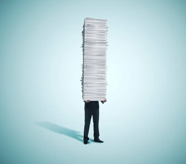 Businessman holding tower of paper — 스톡 사진