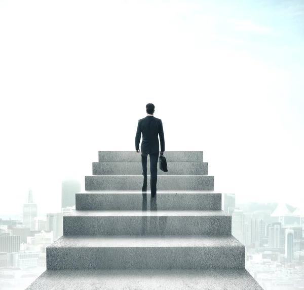 Empresário com pasta subindo escadas — Fotografia de Stock