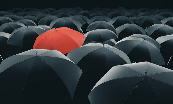 Red umbrella in mass of black umbrellas