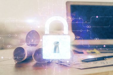 Bilgisayar ve ikon hologramı ile masaüstüne çift pozlama. Veri güvenliği kavramı.