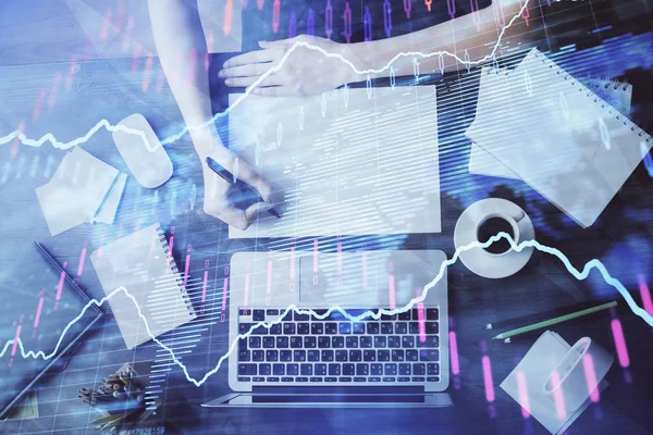 Financial graph displayed on womans hand taking notes background. Concept of research. Multi exposure — Stock Photo, Image