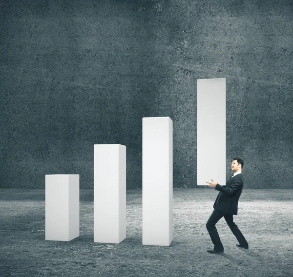 Businessman holding concrete business chart — Stock Photo, Image