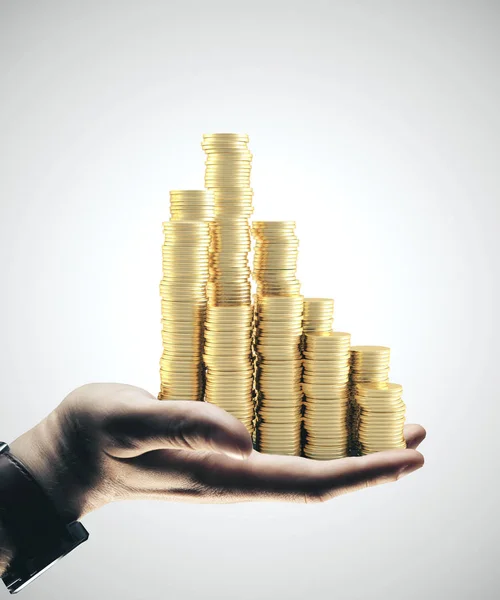 Podnikatel ruka drží zlaté mince — Stock fotografie